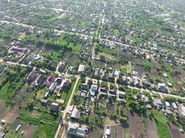 Top view of the village. One can see the roofs of the houses and gardens. Road and water in the village. Village bird's-eye view photo