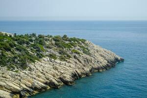 coast of the Mediterranean Sea. The shore is composed of limestone and marble. photo