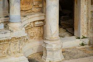 Bas-reliefs of antique scenes on the gables of the amphitheater in Hierapolis, Turkey. photo