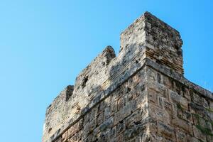 The wall near the gate of Hadrian, the texture of the stone walls of ancient stone blocks. photo
