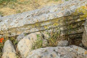 Fragments of ancient buildings, ruins of the ancient city of Hierapolis. Stone blocks with traces of stone machining. photo