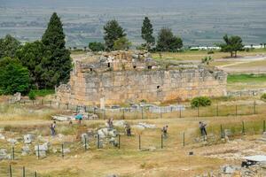 remains of the ancient antique buildings of Hierapolis from limestone blocks, dilapidated walls. photo