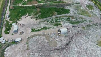 garbage dump with heaps of garbage and treatment facilities. Landfill of garbage outside the village photo