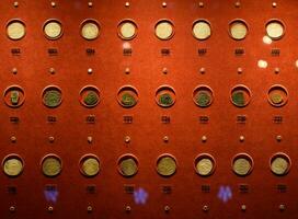 Coins at the Antalya Antiquities Museum. Old coins on the rack with light. photo