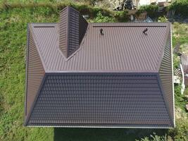 A view from above on the roof of the house. The roof of corrugated sheet. Roofing of metal profile wavy shape photo