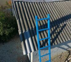 Steel blue staircase to the roof of the barn photo