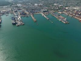 Industrial seaport, top view. Port cranes and cargo ships and barges. photo