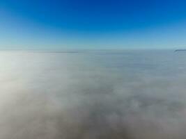 In the skies above the fog. Sunrise over the fog. Clouds near the ground photo