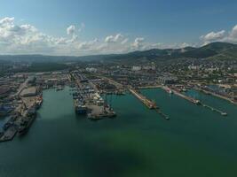 Industrial seaport, top view. Port cranes and cargo ships and barges. photo