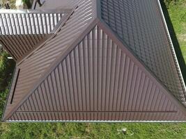 A view from above on the roof of the house. The roof of corrugated sheet. Roofing of metal profile wavy shape photo