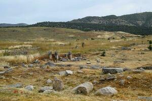 Fragments of ancient buildings, ruins of the ancient city of Hierapolis. Stone blocks with traces of stone machining. photo