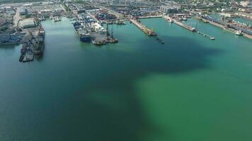 Industrial seaport, top view. Port cranes and cargo ships and barges. photo