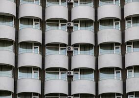 Background texture of balconies and windows of hotel. The wall of the hotel with balconies and windows. photo