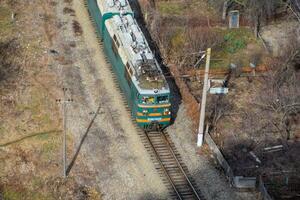 Freight train traveling through the city buildings. photo