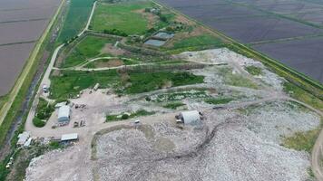 garbage dump with heaps of garbage and treatment facilities. Landfill of garbage outside the village photo
