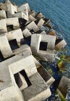 Breakwater of the rectangular stone figures. photo