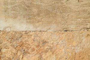 Texture of processed ancient marble block. Traces of ancient tools photo