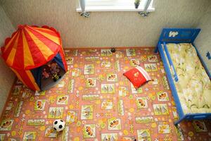 Childrens room, top view. Toys on the floor and a crib in the corner. photo