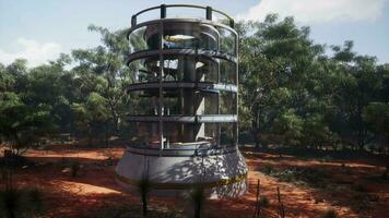 A futuristic glass greenhouse tower in the midst of a lush forest video