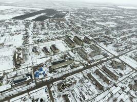 Winter view from the bird's eye view of the village. The streets are covered with snow photo