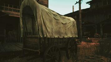 An antique covered wagon in a rustic field setting video