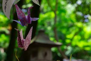 A paper crane swaying in the wind at the traditional street close up photo