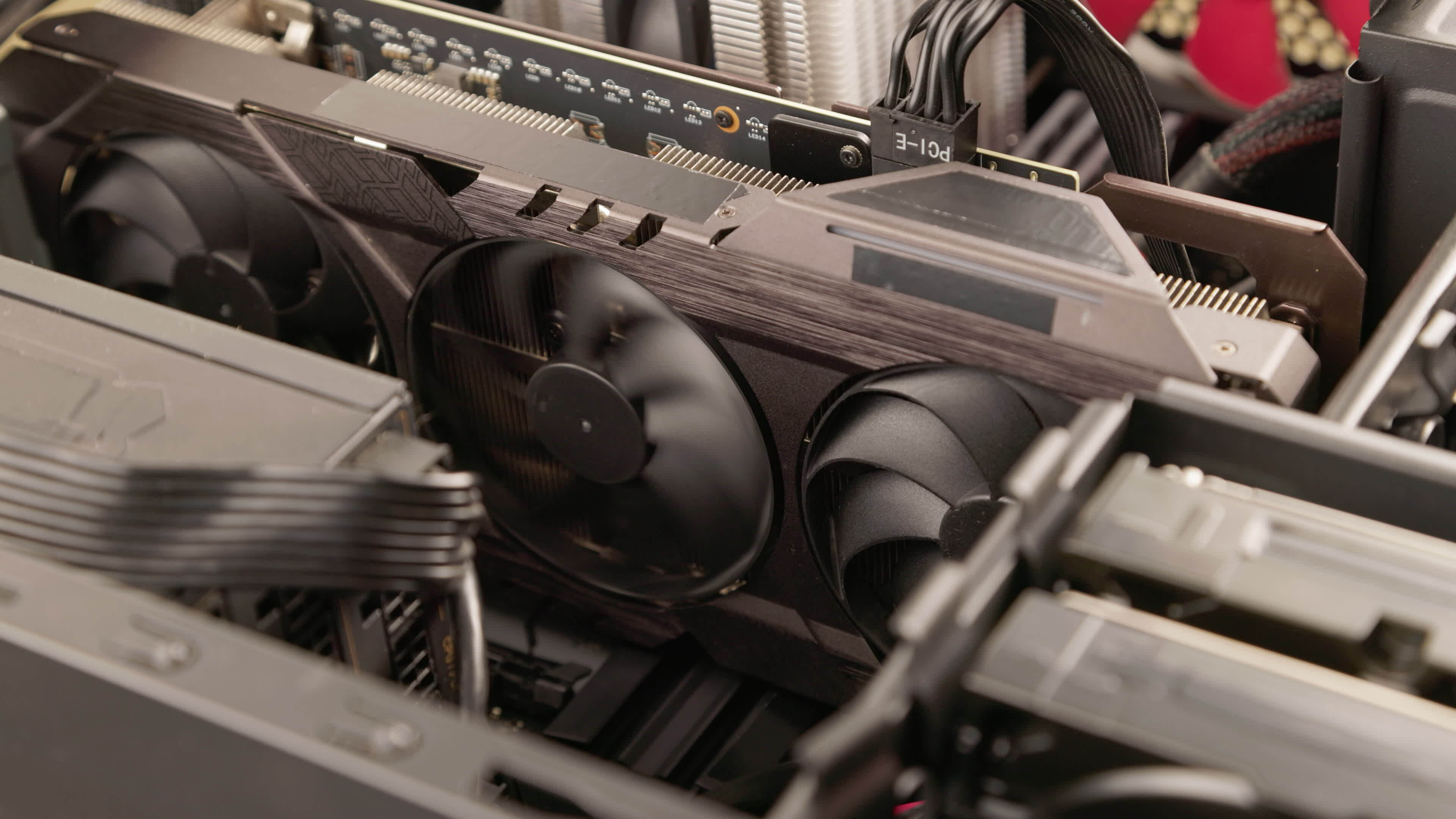 caucasian hands spinning fans of large air cooled computer graphic card