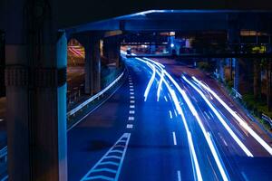 A night traffic jam at the city street under the highway in Tokyo photo