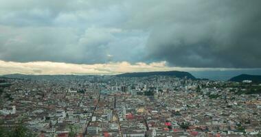 Time-lapse of  panoramic view of the historic center of the city of Quito changing from afternoon to night with a cloudy sky - Ecuador video