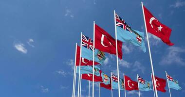 Fiji and Turkey Flags Waving Together in the Sky, Seamless Loop in Wind, Space on Left Side for Design or Information, 3D Rendering video