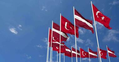 Latvia and Turkey Flags Waving Together in the Sky, Seamless Loop in Wind, Space on Left Side for Design or Information, 3D Rendering video