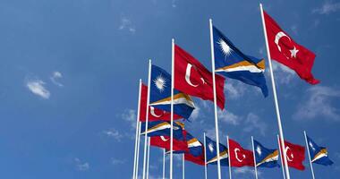 Marshall Islands and Turkey Flags Waving Together in the Sky, Seamless Loop in Wind, Space on Left Side for Design or Information, 3D Rendering video