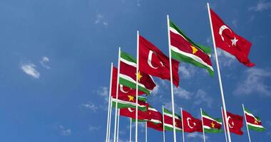 Suriname and Turkey Flags Waving Together in the Sky, Seamless Loop in Wind, Space on Left Side for Design or Information, 3D Rendering video