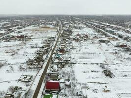 Winter view from the bird's eye view of the village. The streets are covered with snow photo