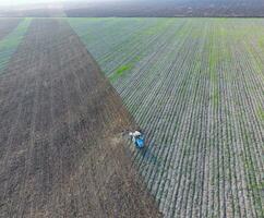 Top view of the tractor that plows the field. disking the soil. Soil cultivation after harvest photo