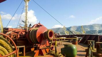 Mechanisms of tension control ropes. Winches. Equipment on the deck of a cargo ship or port photo