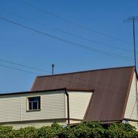 Detached house with a roof made of steel sheets. photo