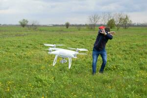 A man hides himself from a collision with a drone. Quadrocopter photo