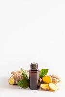 Medical bottle with organic ginger root oil for skin care, hair care, spa treatments. Natural care. White vertical background. A copy space. photo