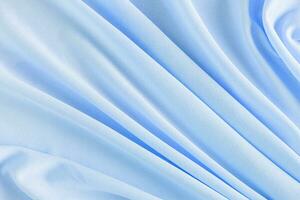 Stylish festive blue blossom background. Background image of factory fabric. Gorgeous soft pleats. A copy space photo