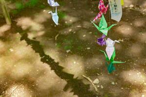 A paper crane swaying in the wind at the traditional street photo