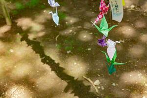 A paper crane swaying in the wind at the traditional street photo