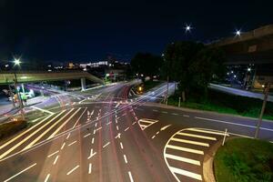 A night timelapse of traffic jam at the city intersection in Tokyo wide shot photo