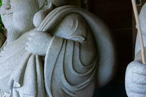 A Japanese guardian statue at the traditional street in Tokyo photo