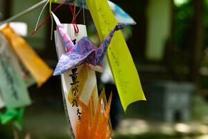 A paper crane swaying in the wind at the traditional street close up photo