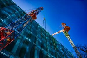 Cranes at the under construction in Tokyo low angle photo