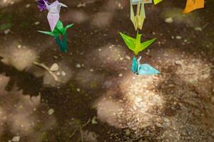 A paper crane swaying in the wind at the traditional street photo