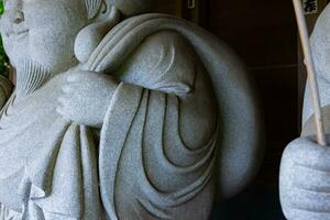 A Japanese guardian statue at the traditional street in Tokyo photo