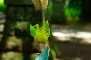 A paper crane swaying in the wind at the traditional street close up photo