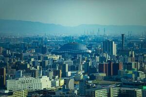 A dusk cityscape by high angle view near Kyocera dome in Osaka telephoto shot photo